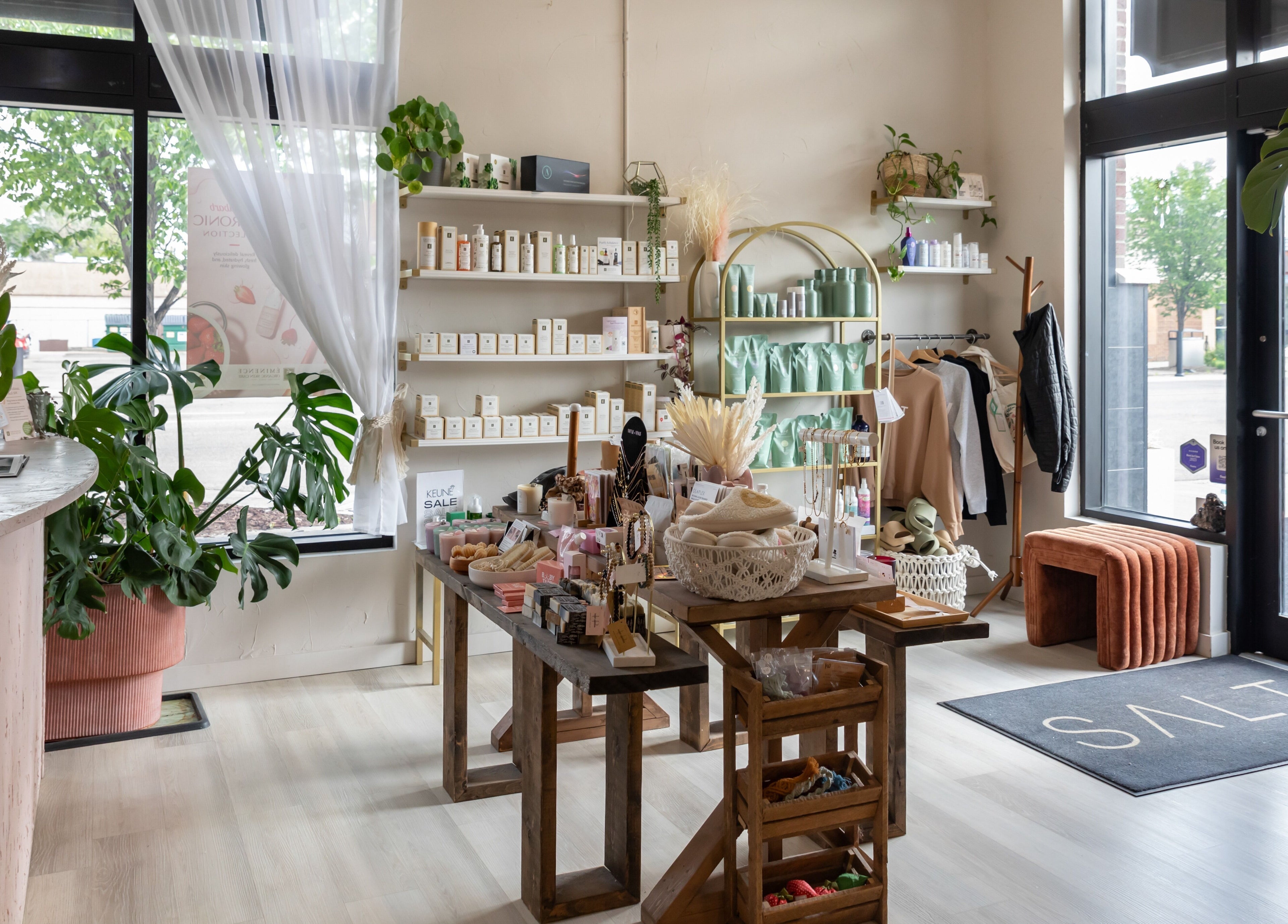 Salt Day Spa interior showcasing eco-friendly products in Leduc, Alberta, CA with greenery and natural light.