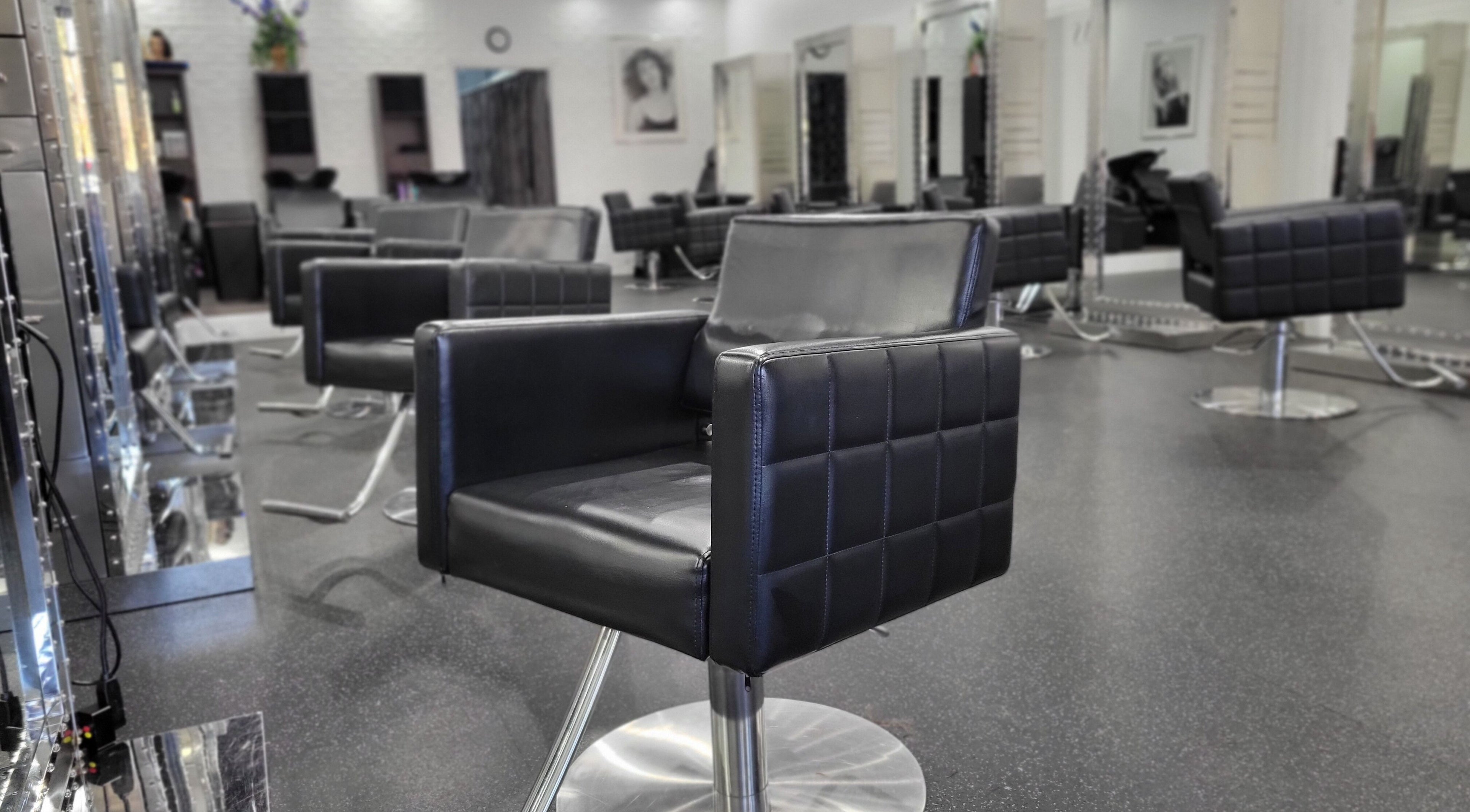 Stylish salon chairs at All About Beauty Salon in Alpharetta, Georgia, US, showcasing modern elegance.