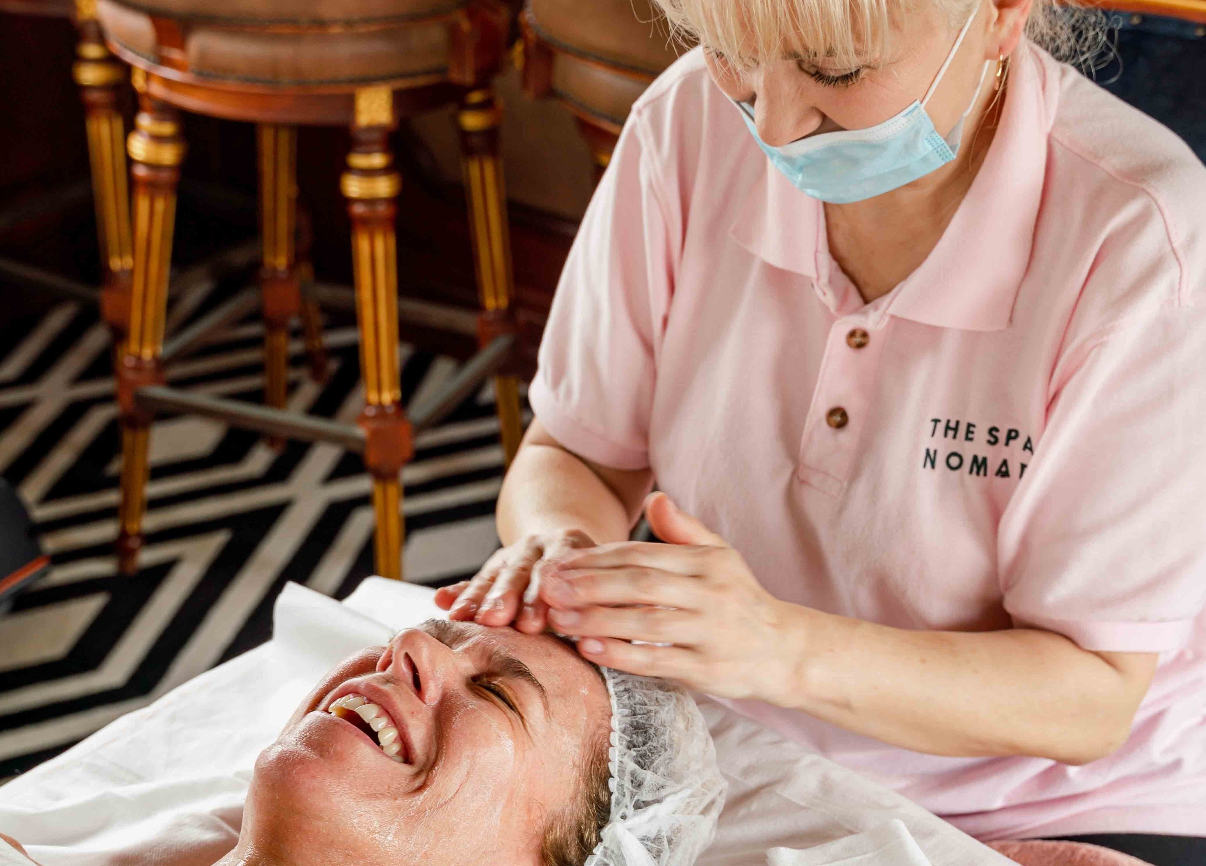 A client enjoys a facial massage by The Spa Nomad in Auckland, Auckland, NZ, enhancing relaxation and wellness.