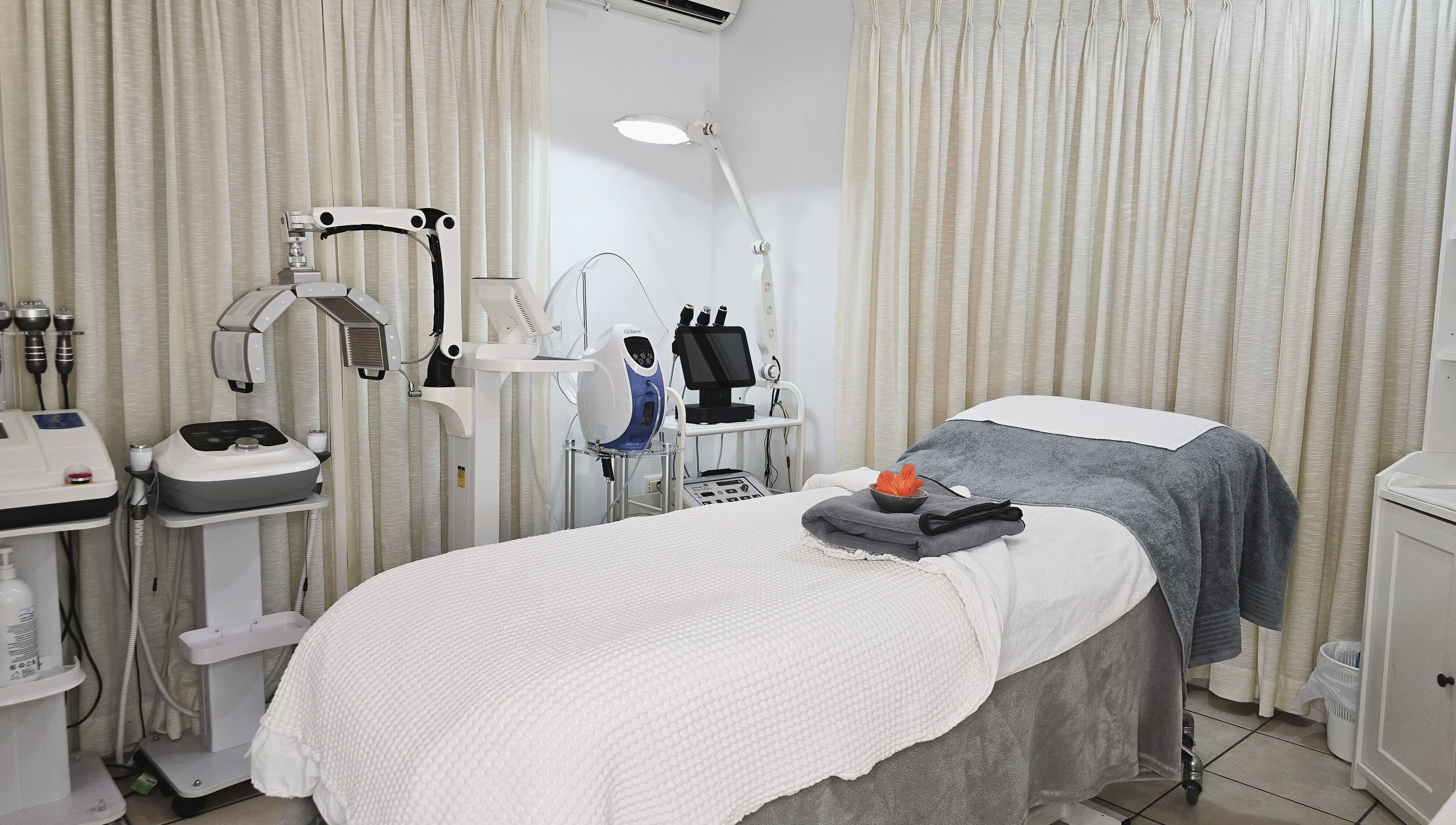 Serenity Glow Skin Rituals & Wellness offers a cozy treatment room in Morningside, Queensland, AU with advanced equipment.