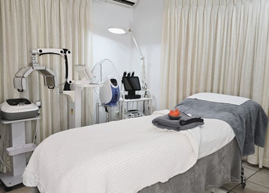 Serenity Glow Skin Rituals & Wellness offers a cozy treatment room in Morningside, Queensland, AU with advanced equipment.