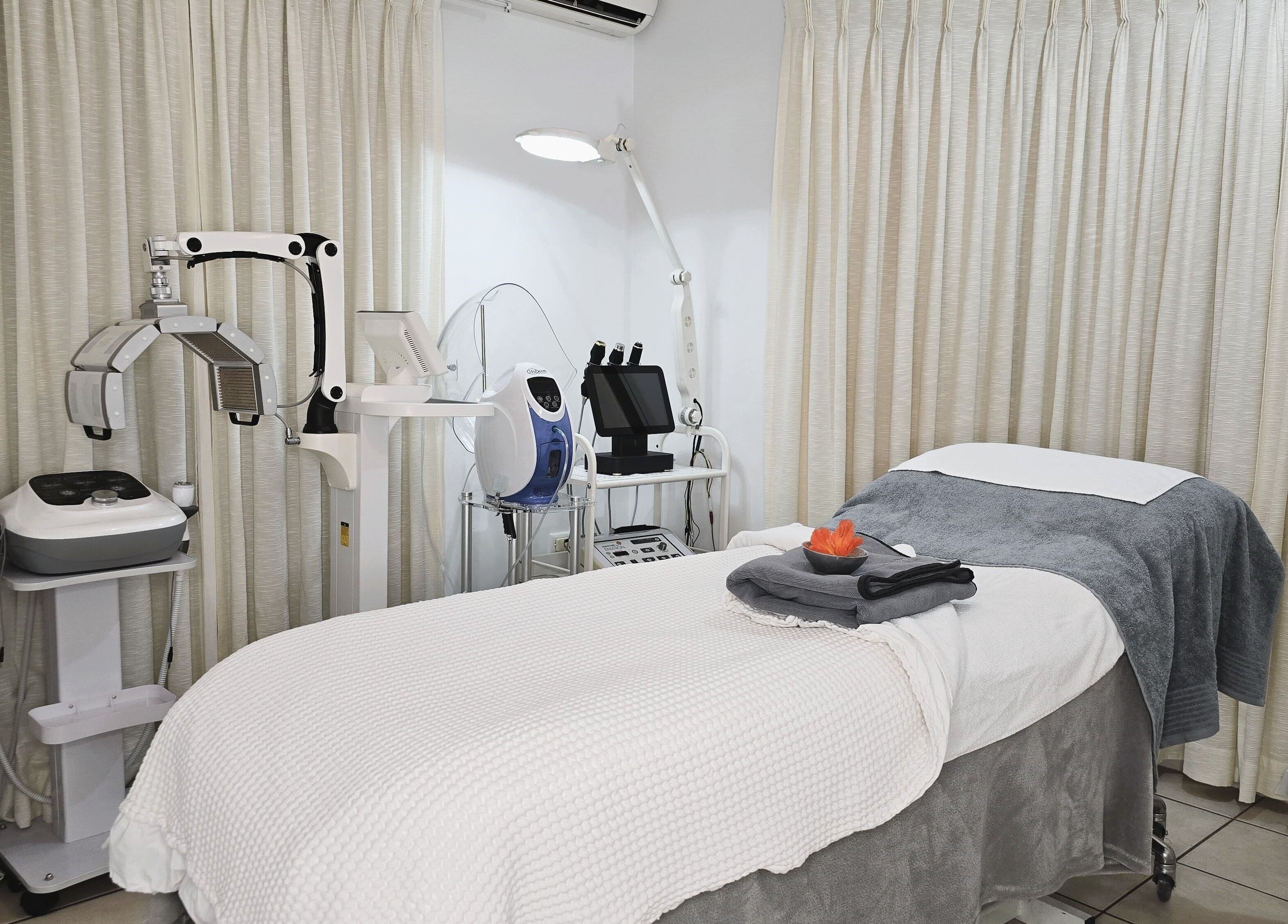 Serenity Glow Skin Rituals & Wellness offers a cozy treatment room in Morningside, Queensland, AU with advanced equipment.