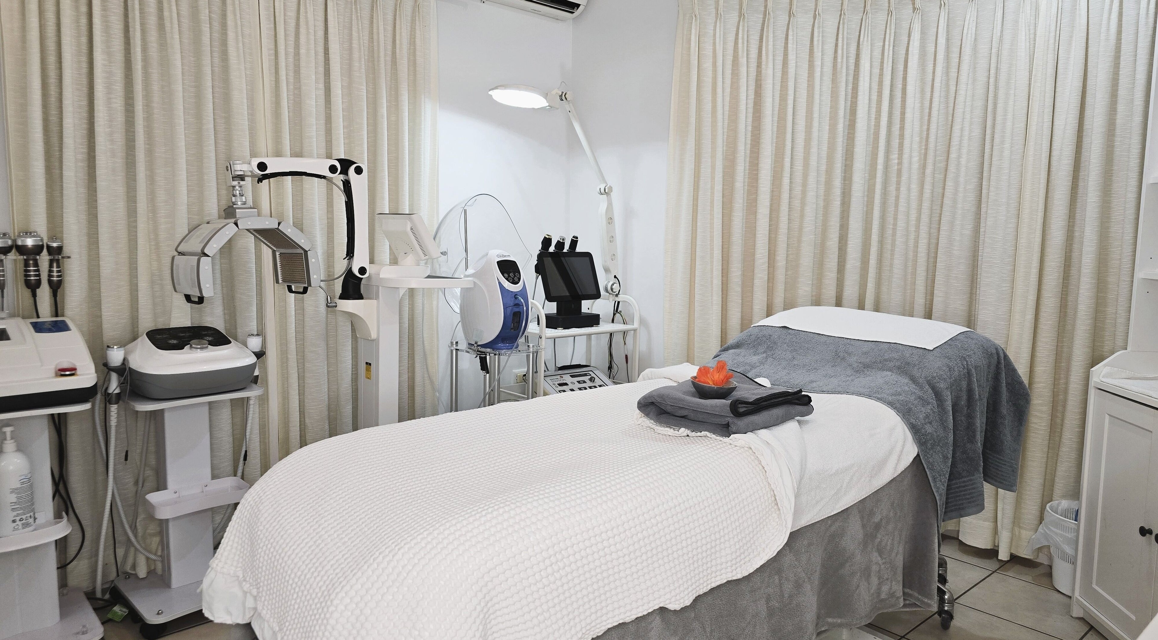 Serenity Glow Skin Rituals & Wellness offers a cozy treatment room in Morningside, Queensland, AU with advanced equipment.