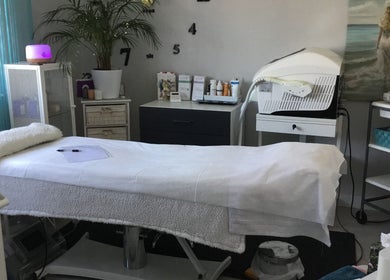 Relaxing spa room at Cambridge Cosmetology, Cambridge, England, GB, with treatment bed and equipment.