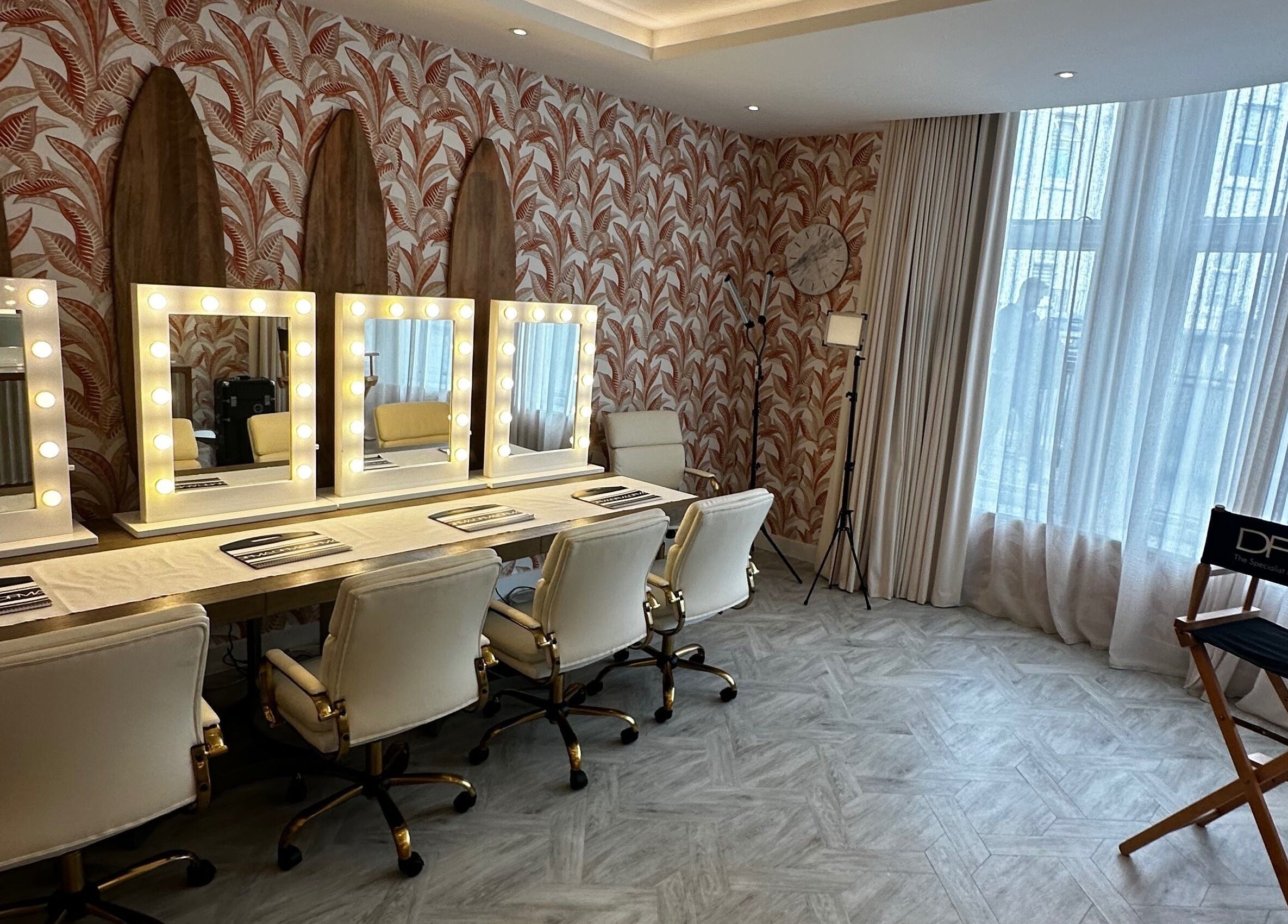 Elegant makeup station at Dfma Make Up & Hair Bar, Poole, England, GB with artist chairs and mirrors.