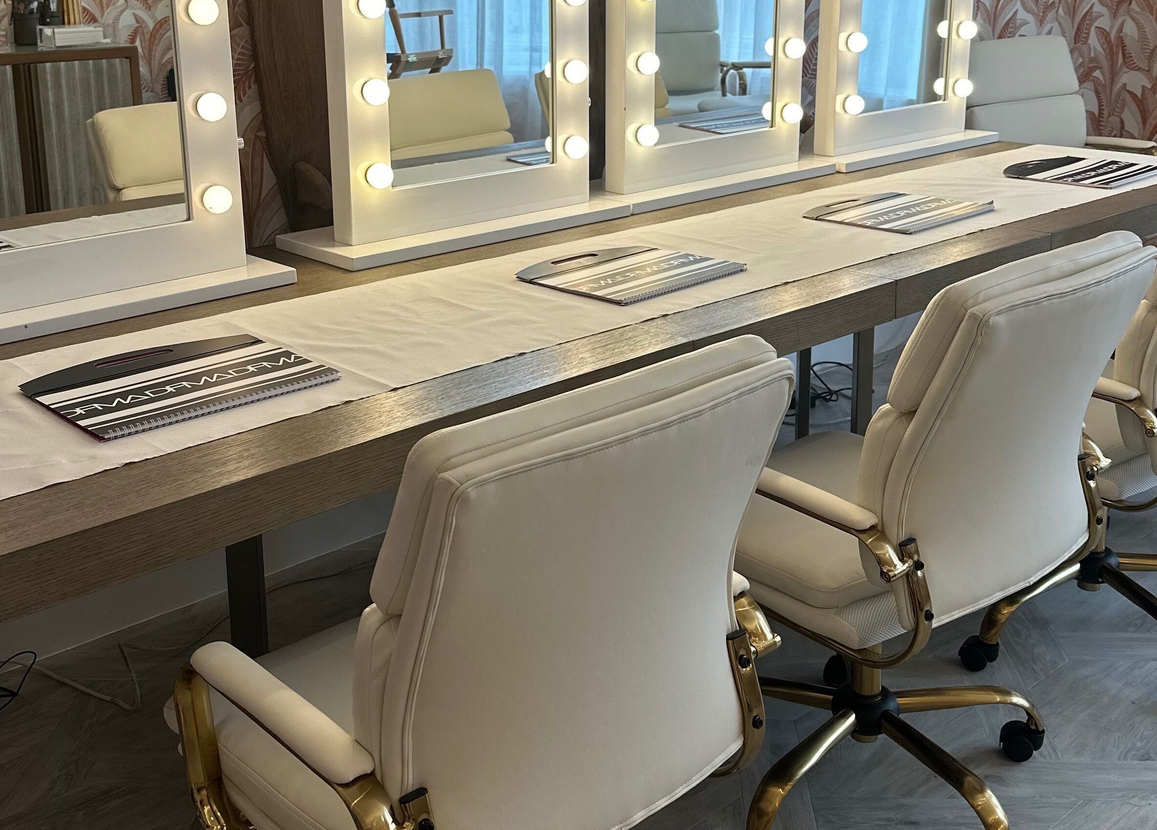 Vanity mirrors at Dfma Make Up & Hair Bar in Poole, England, GB create a luxe beauty experience.