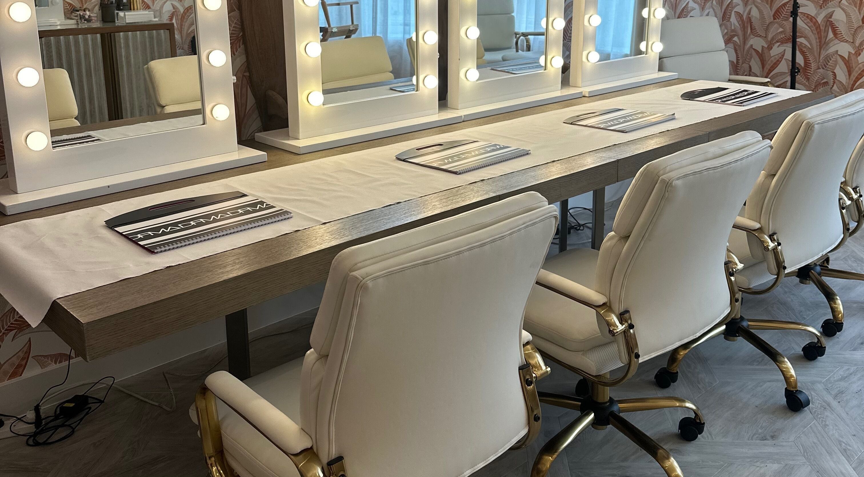 Vanity mirrors at Dfma Make Up & Hair Bar in Poole, England, GB create a luxe beauty experience.