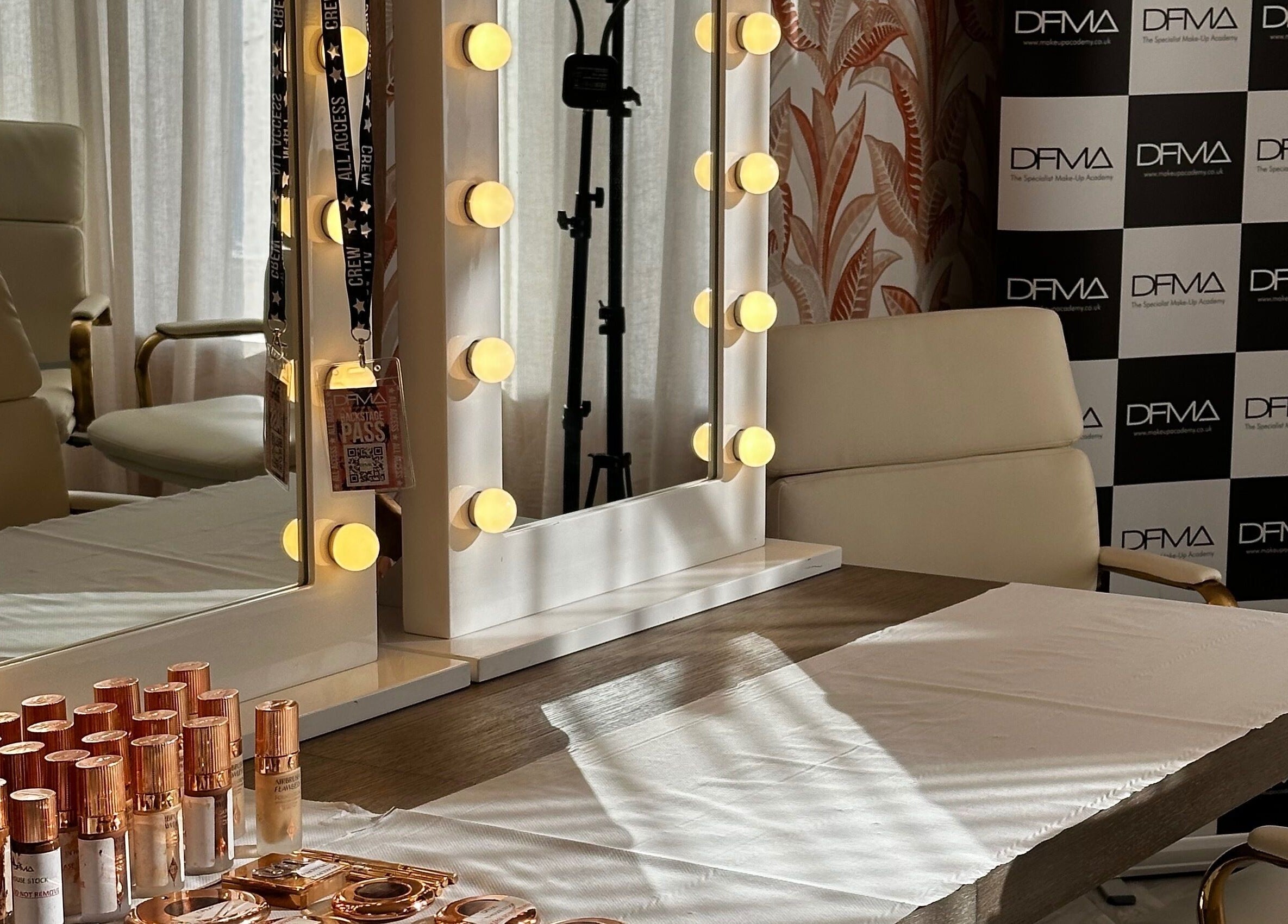 Elegant makeup vanity at Dfma Make Up & Hair Bar, Poole, England, GB, displaying beauty products and lighting.