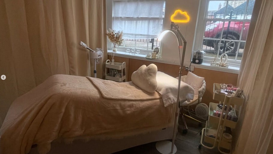 Relaxing treatment room at AmyEBeauty, Suffolk, England, GB with soft lighting and plush decor.