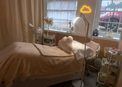 Relaxing treatment room at AmyEBeauty, Suffolk, England, GB with soft lighting and plush decor.