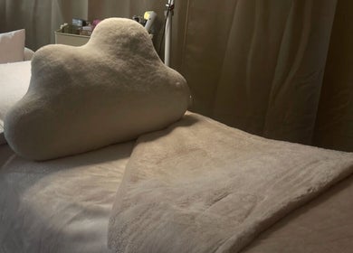 Plush massage bed at AmyEBeauty in Suffolk, England, GB, offering a serene wellness experience.