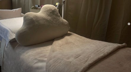 Plush massage bed at AmyEBeauty in Suffolk, England, GB, offering a serene wellness experience.