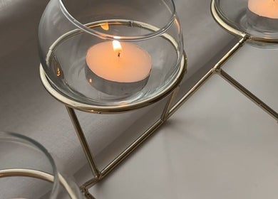 Elegant tea light candles in glass holders at AmyEBeauty, Suffolk, England, GB, creating a calming ambiance.