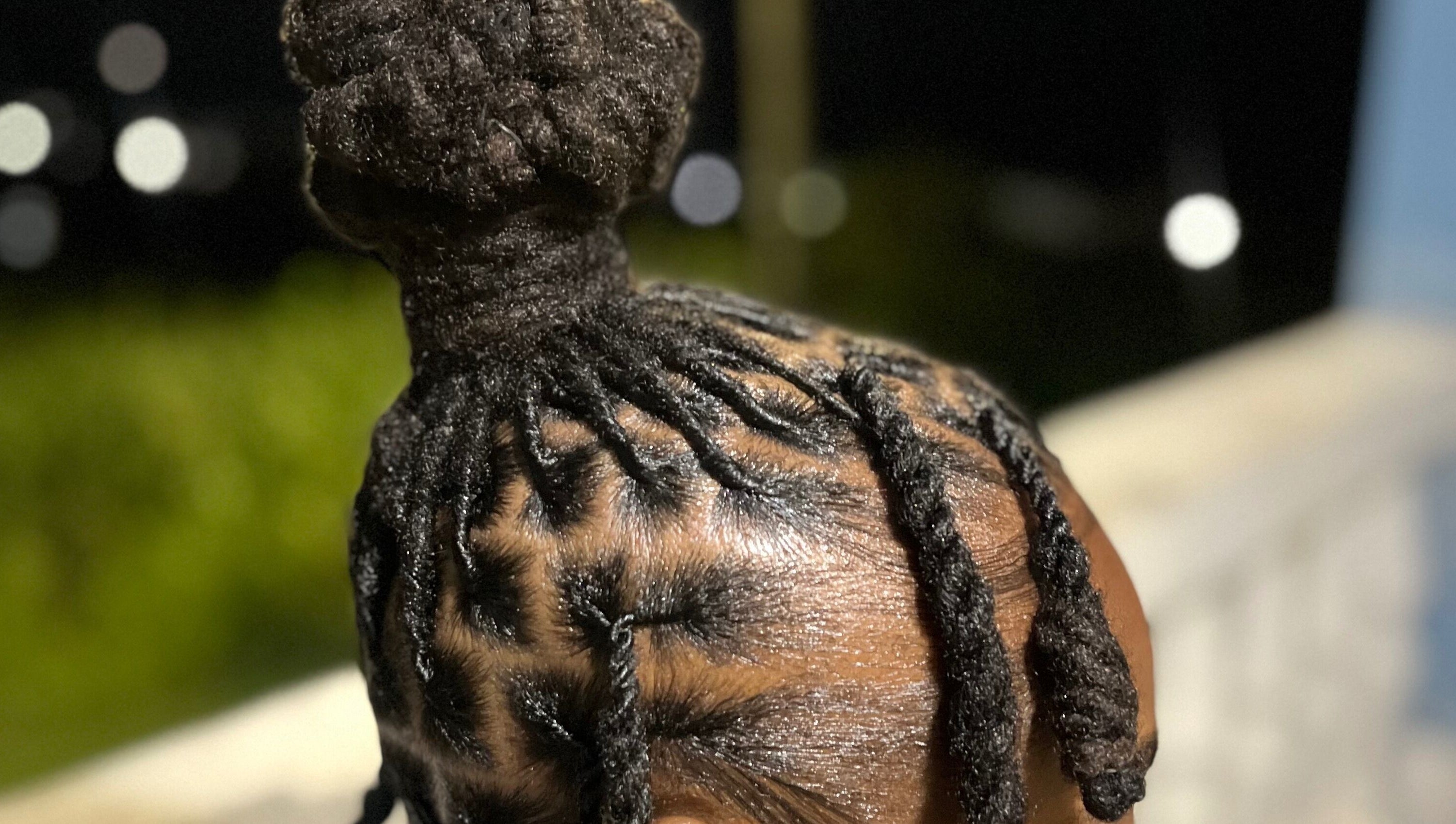 Intricate loc bun hairstyle at Locsdesire, Trinity, KN showcasing expert craftsmanship.
