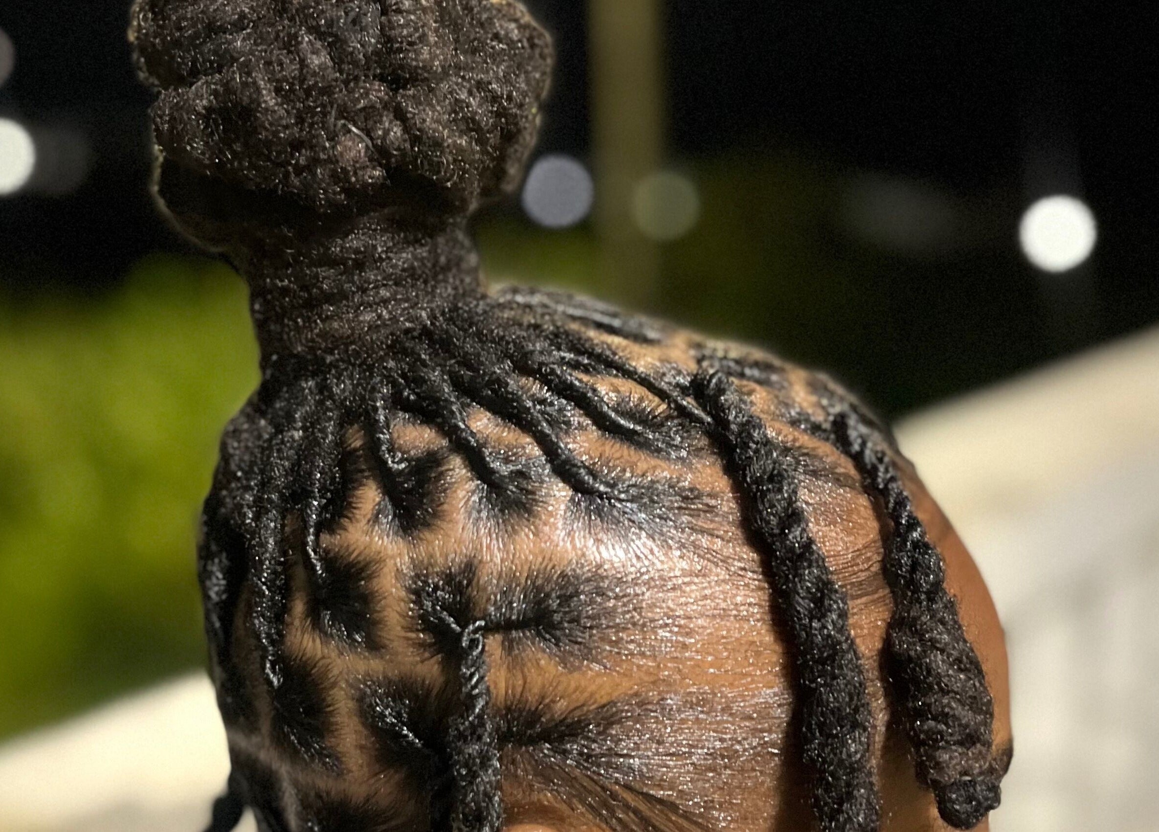 Intricate loc bun hairstyle at Locsdesire, Trinity, KN showcasing expert craftsmanship.