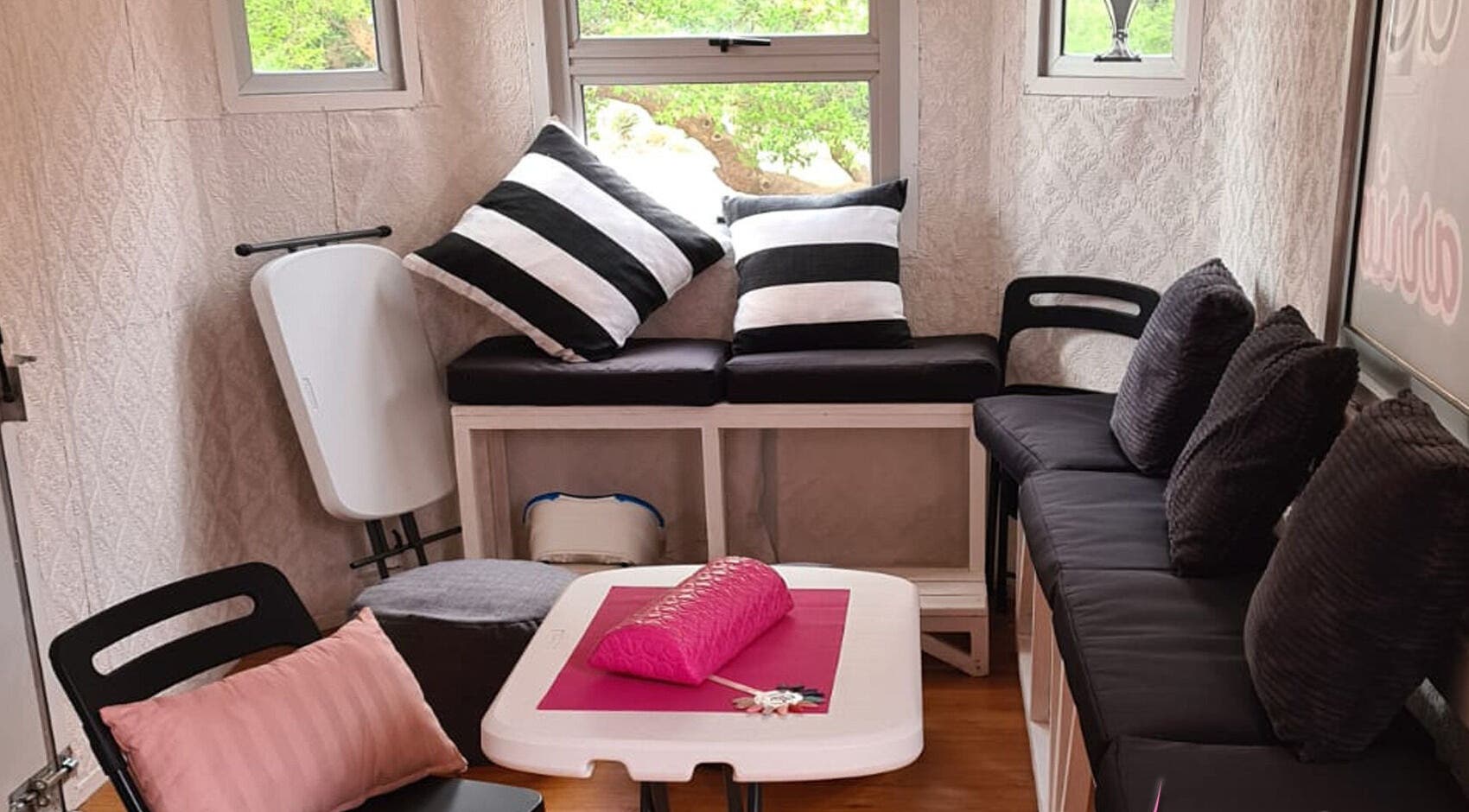 Cozy seating inside Beauty Truck, Roodepoort, Gauteng, ZA, featuring stylish cushions and decor.
