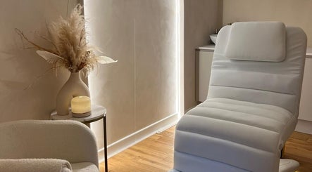Luxurious treatment room at Beauty By Amineh, Cambridge, England, GB, featuring elegant decor and plush seating.