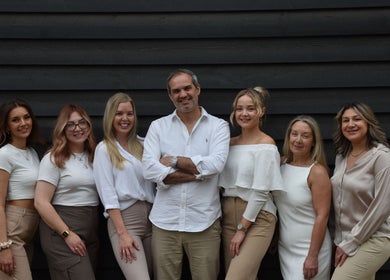 Team at Beauty By Amineh in Cambridge, England, GB, smiling outside studio.
