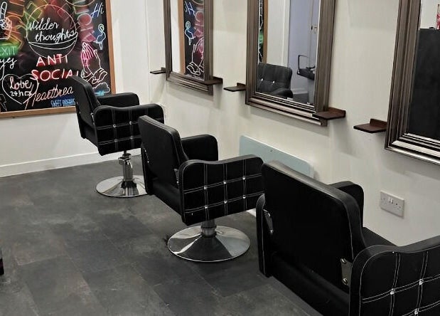 Elegant salon chairs and mirrors at The Lounge Forres Ltd, Forres, Scotland, GB, showcasing modern interior.