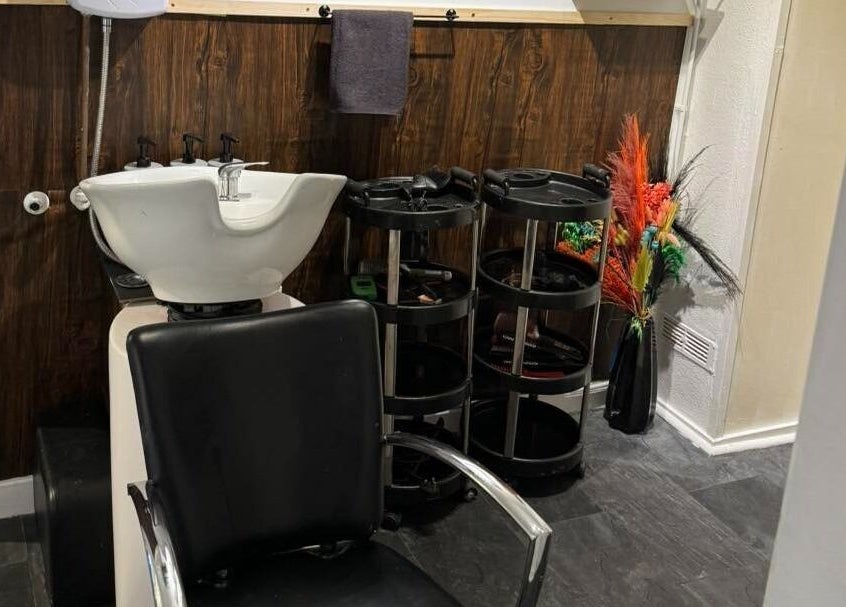 Elegant hair washing station at The Lounge Forres Ltd, Forres, Scotland, GB, with sleek black chair.