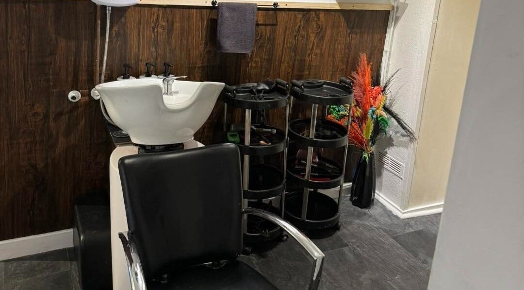 Elegant hair washing station at The Lounge Forres Ltd, Forres, Scotland, GB, with sleek black chair.