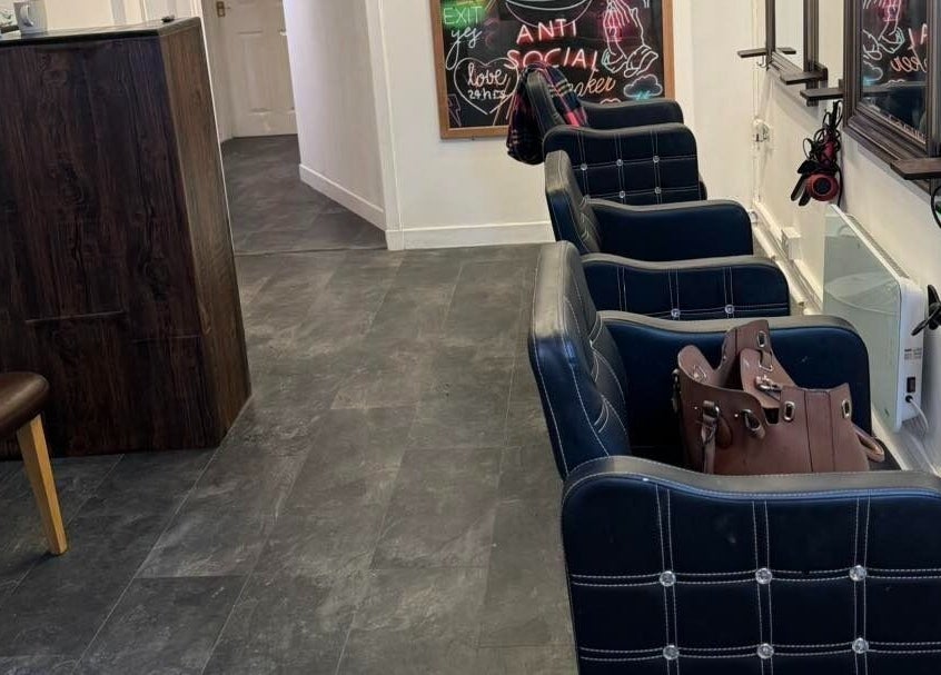 Modern seating area inside The Lounge Forres Ltd, Forres, Scotland, GB with stylish black chairs.