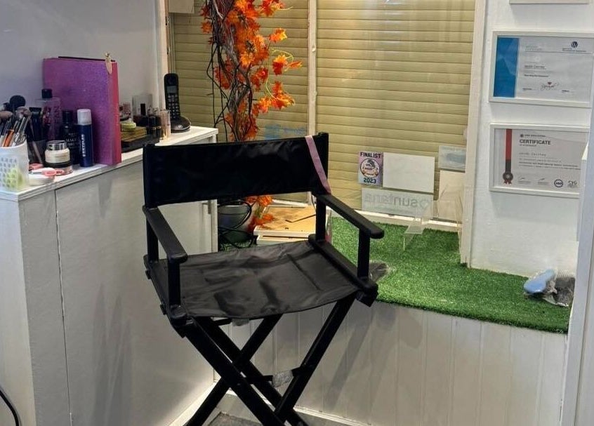 Makeup station with chair at The Lounge Forres Ltd in Forres, Scotland, GB. Beauty products displayed neatly.