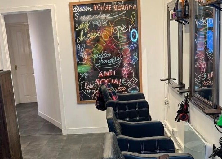 Elegant salon chairs and neon art at The Lounge Forres Ltd, Forres, Scotland, GB.