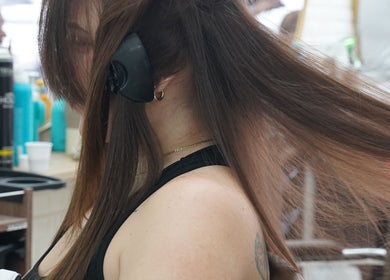 Client getting hair style at Dominican Salon - West Kendall in Miami, Florida, US. Beauty services in action.
