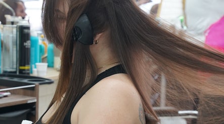 Client getting hair style at Dominican Salon - West Kendall in Miami, Florida, US. Beauty services in action.