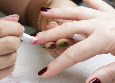 Nail artist applying polish at Dominican Salon - West Kendall, Miami, Florida, US.