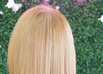 Blonde hair at Dominican Salon - West Kendall in Miami, Florida, US with a garden backdrop.
