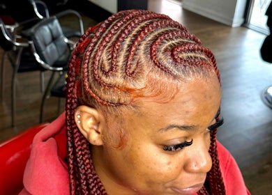 Intricate red braids styled at Nonniestylez, Decatur, Georgia, US. Showcasing expert craftsmanship.