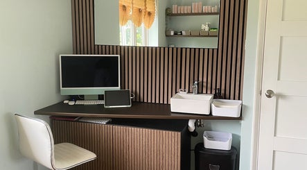 Modern workspace at Oxley Aesthetics, Hemel Hempstead, England, GB featuring sleek computer and stylish decor.