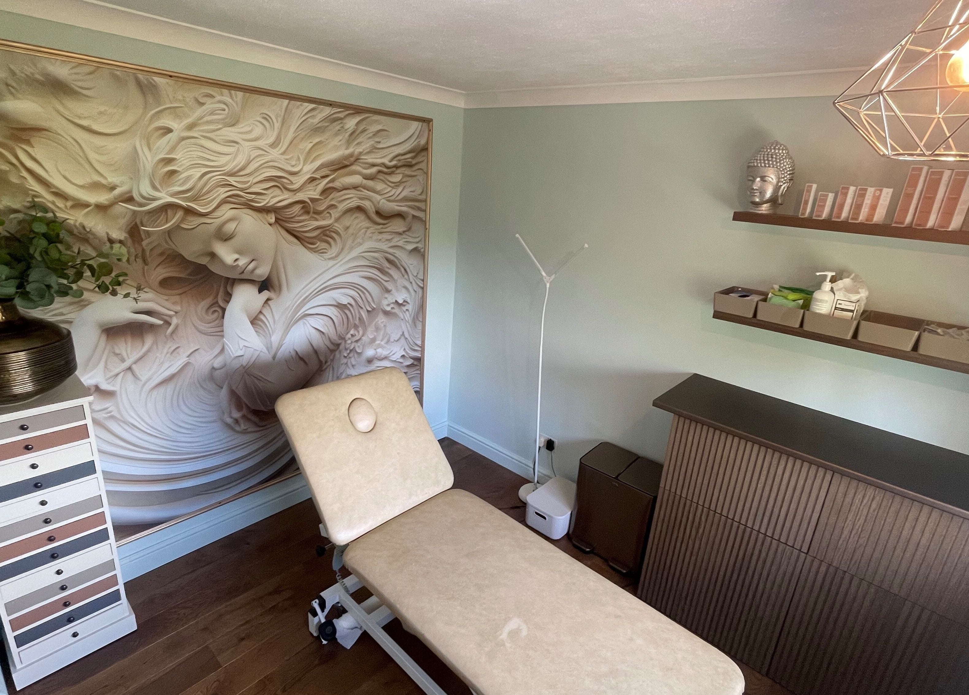 Calming treatment room at Oxley Aesthetics, Hemel Hempstead, England, GB with wall art and decor.