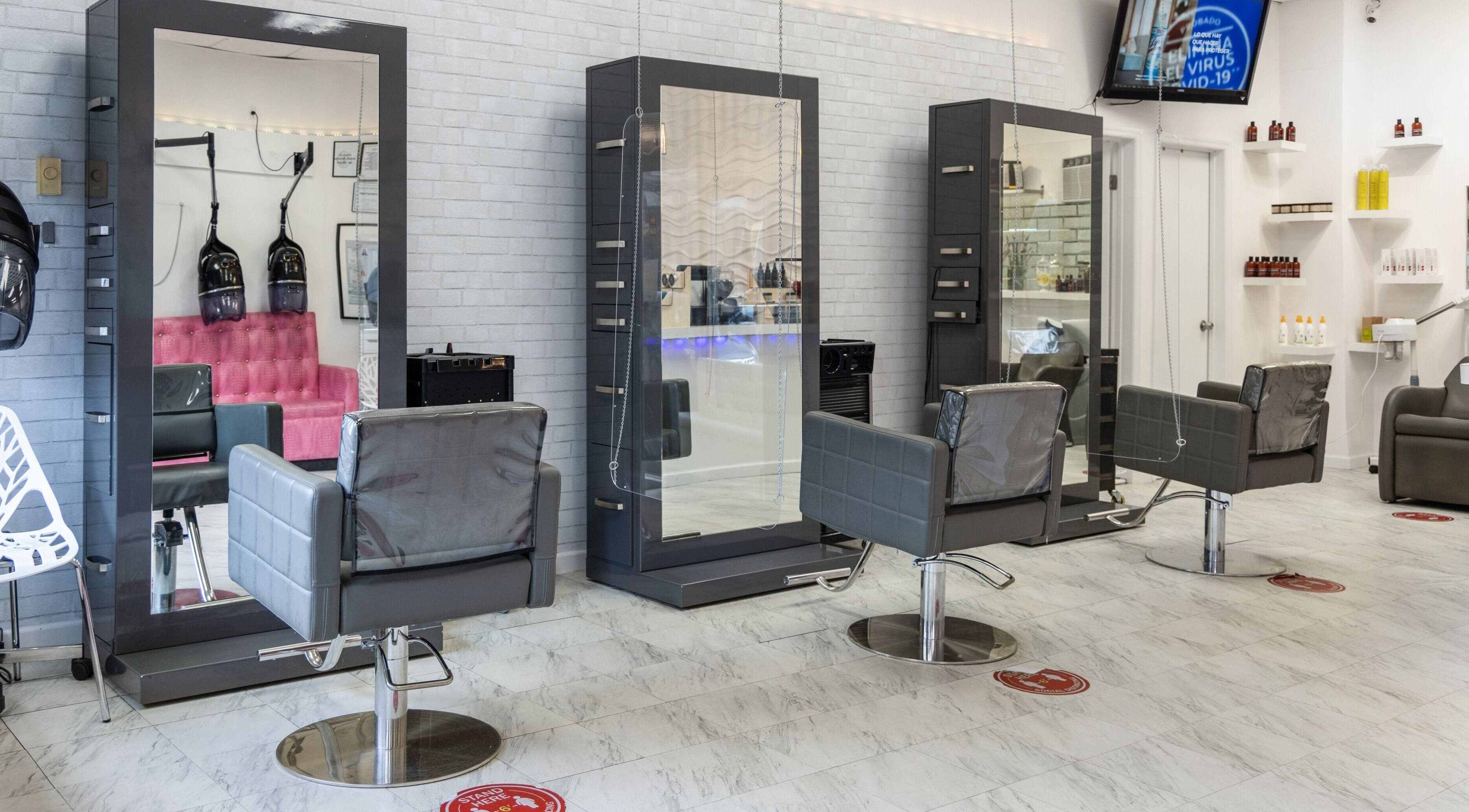 Stylish salon interior at NIKKI MAAR SALON, West New York, New Jersey, US featuring modern chairs and mirrors.