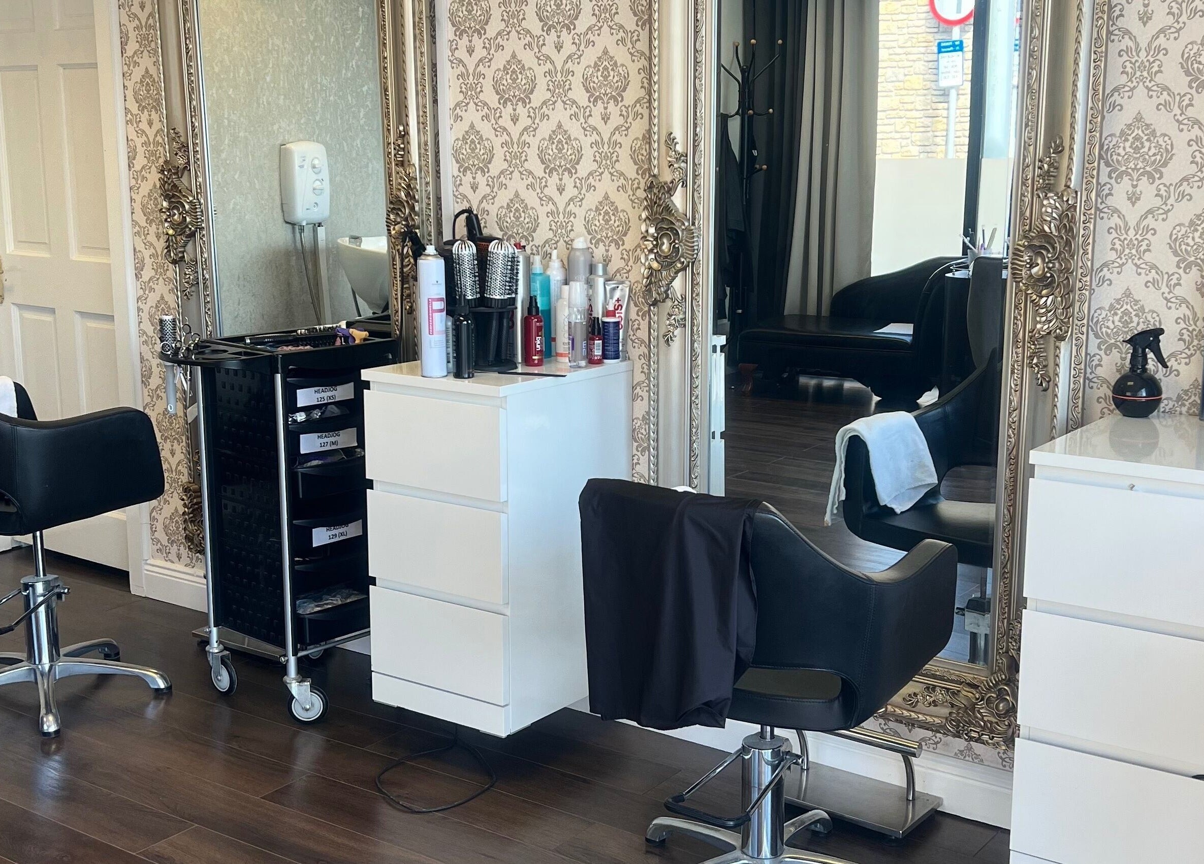 Stylish interior of Cristyle Hair And Beauty in Mullingar, County Westmeath, IE featuring chic salon chairs and mirrors.