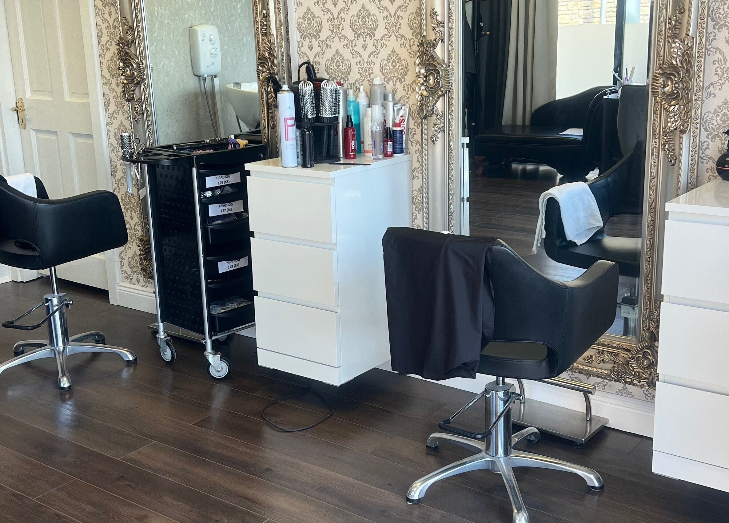 Stylish hair station at Cristyle Hair And Beauty, Mullingar, County Westmeath, IE showcasing chairs and mirrors.