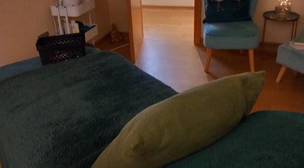 Relaxing treatment room at Aura Therapies, Dronfield Derbyshire, England, GB featuring cozy seating and ambient decor.