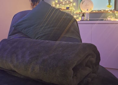 Relaxing therapy room at Aura Therapies in Dronfield, Derbyshire, England, GB with warm lighting and comfortable decor.