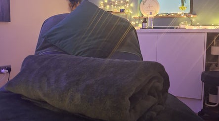 Relaxing therapy room at Aura Therapies in Dronfield, Derbyshire, England, GB with warm lighting and comfortable decor.