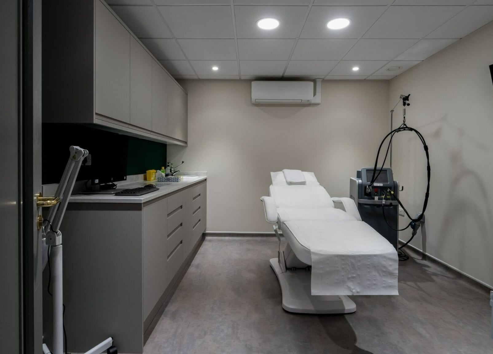 Modern treatment room at Aura Skin Clinic in Milton Keynes, England, GB, featuring a comfortable therapy chair.