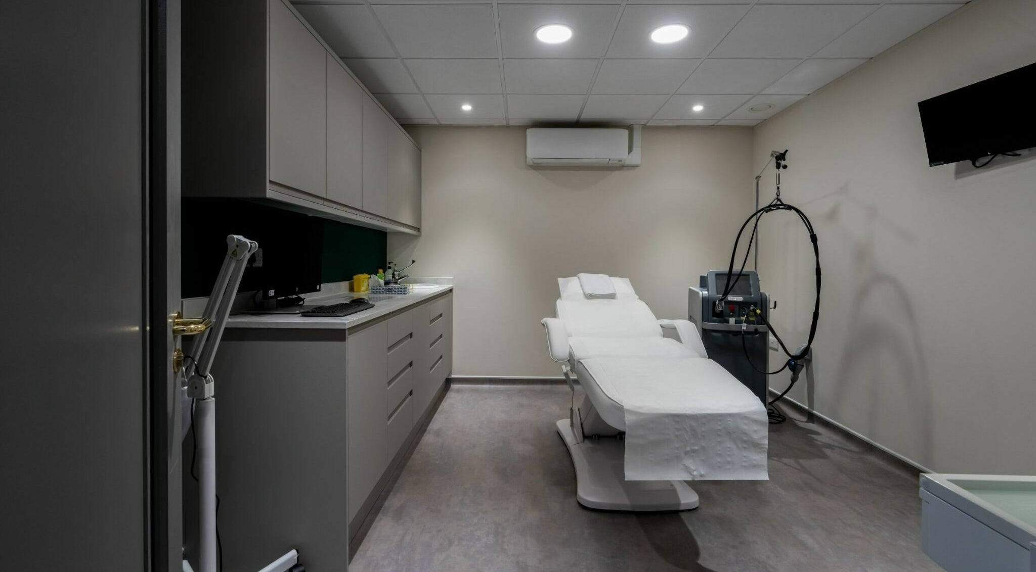 Modern treatment room at Aura Skin Clinic in Milton Keynes, England, GB, featuring a comfortable therapy chair.