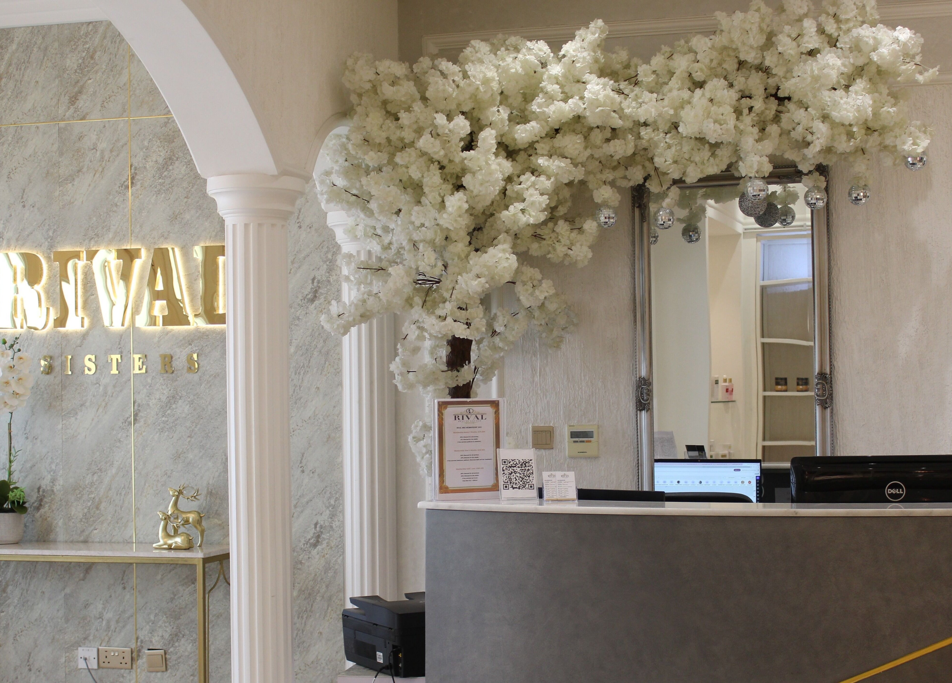 Elegant reception at Rival Sister Salon L.L.C Sisters in Abu Dhabi, AE with floral decor and mirrored wall.