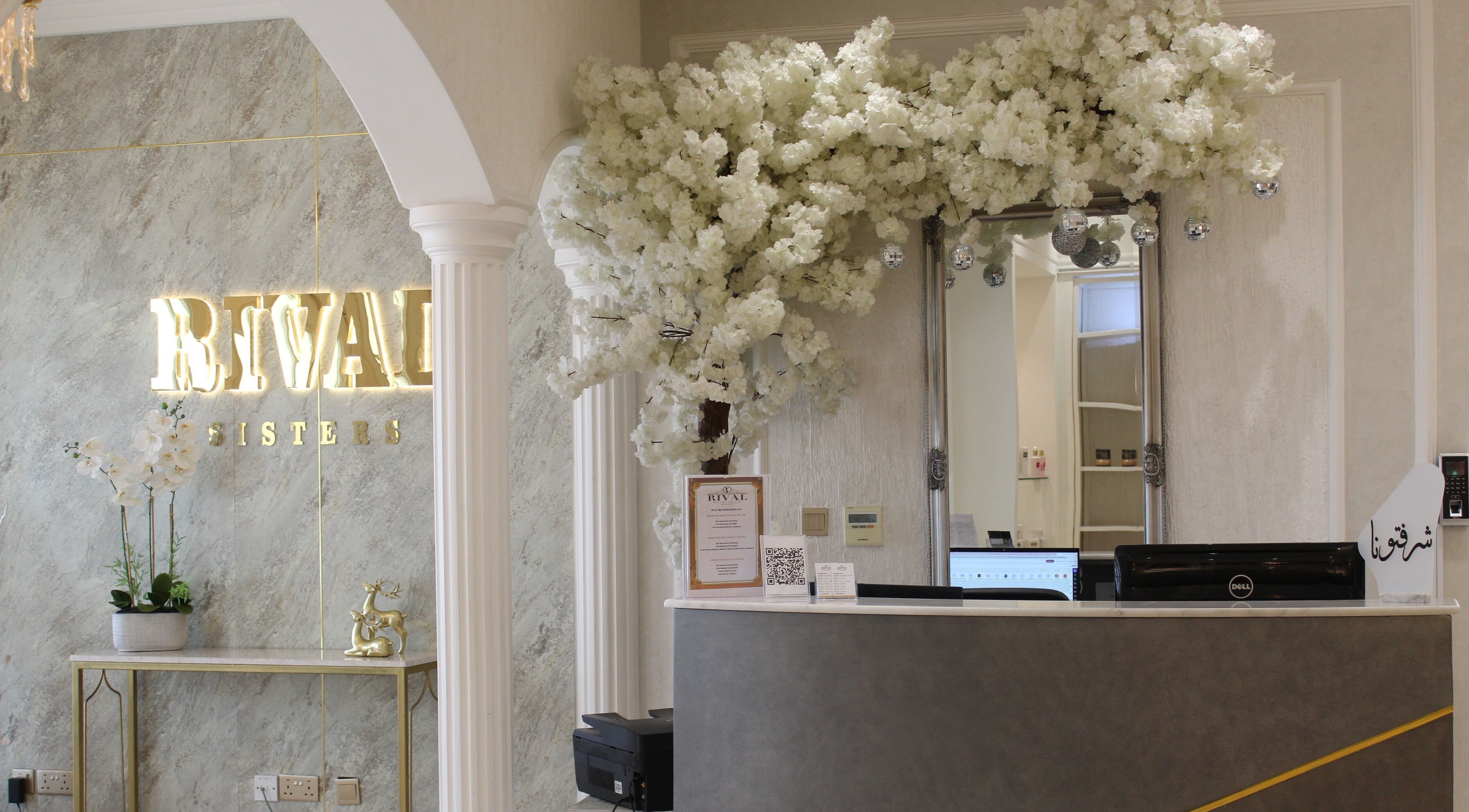 Elegant reception at Rival Sister Salon L.L.C Sisters in Abu Dhabi, AE with floral decor and mirrored wall.
