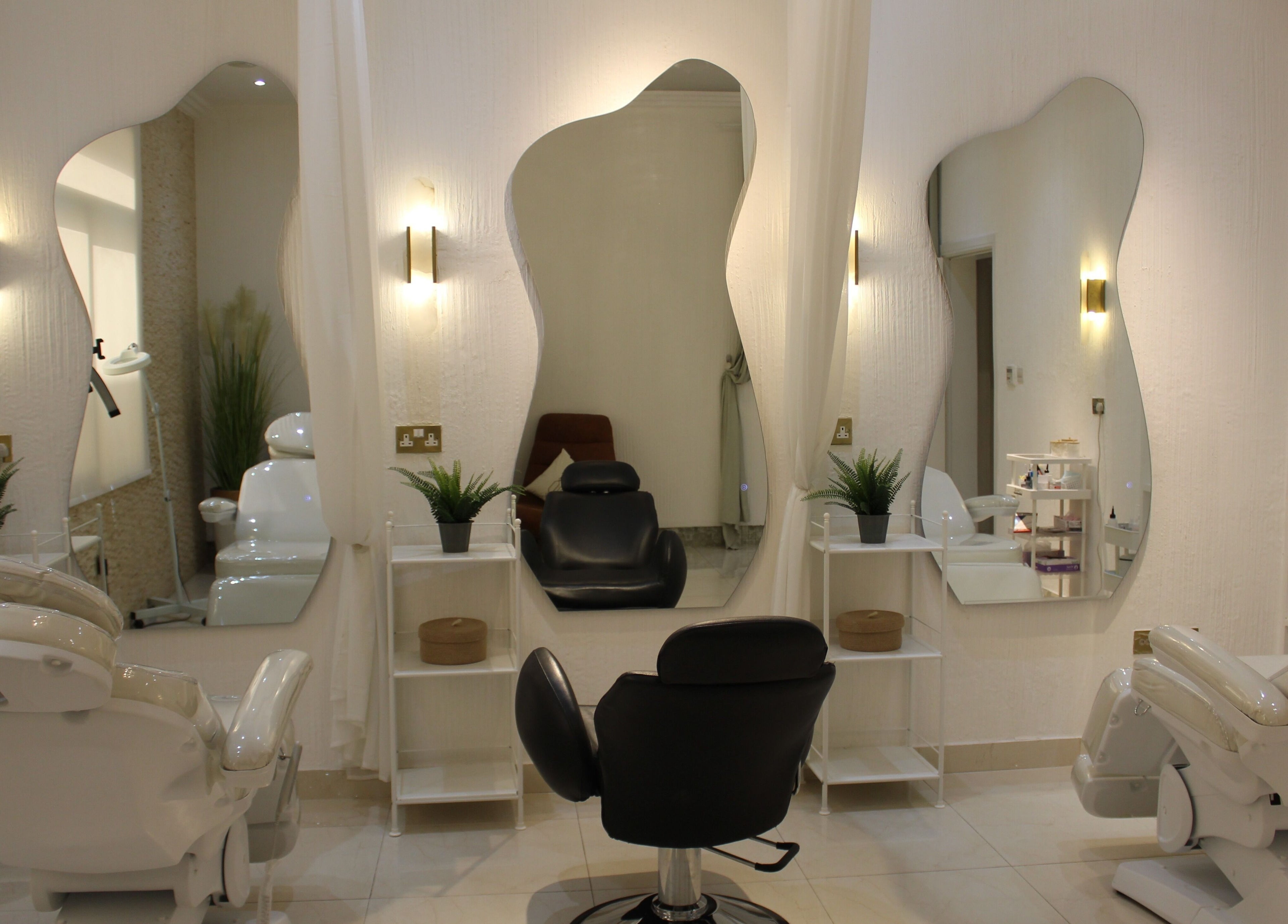Elegant salon interior at Rival Sister Salon L.L.C Sisters in Abu Dhabi, AE with stylish mirrors and chairs.