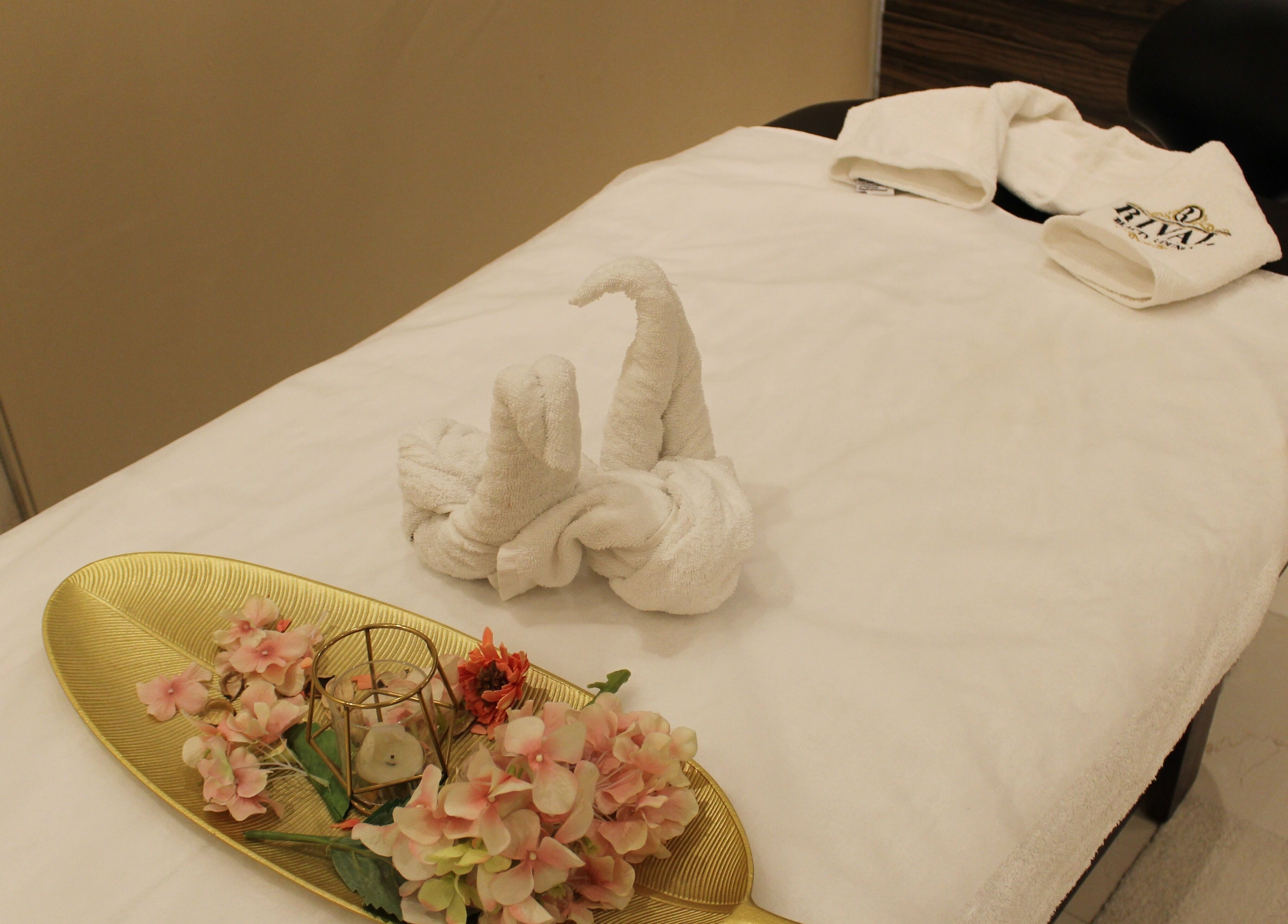 Elegant spa bed with floral decor at Rival Sister Salon L.L.C Sisters, Abu Dhabi, AE.