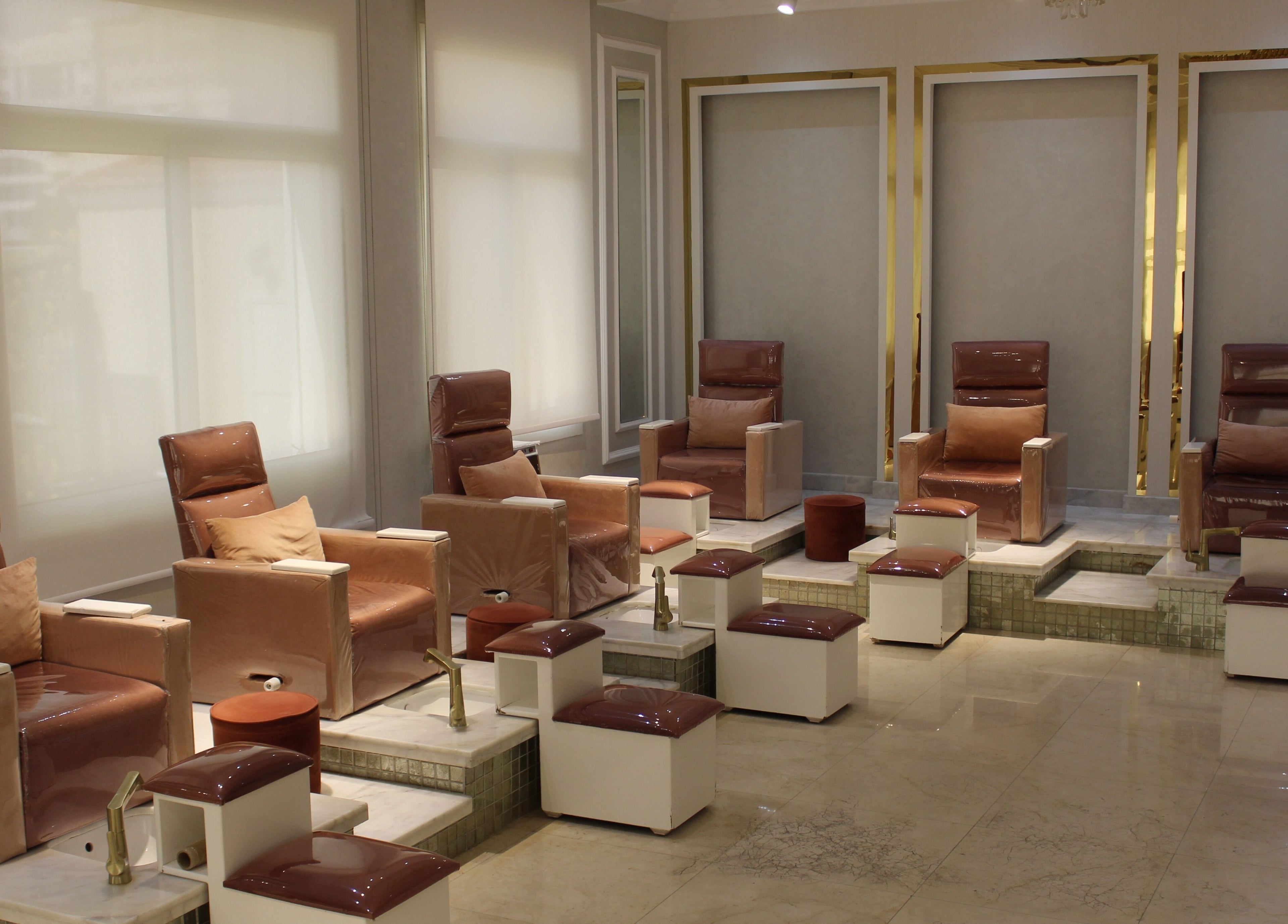 Elegant pedicure area at Rival Sister Salon L.L.C Sisters, Abu Dhabi, AE, featuring plush seating and footrests.