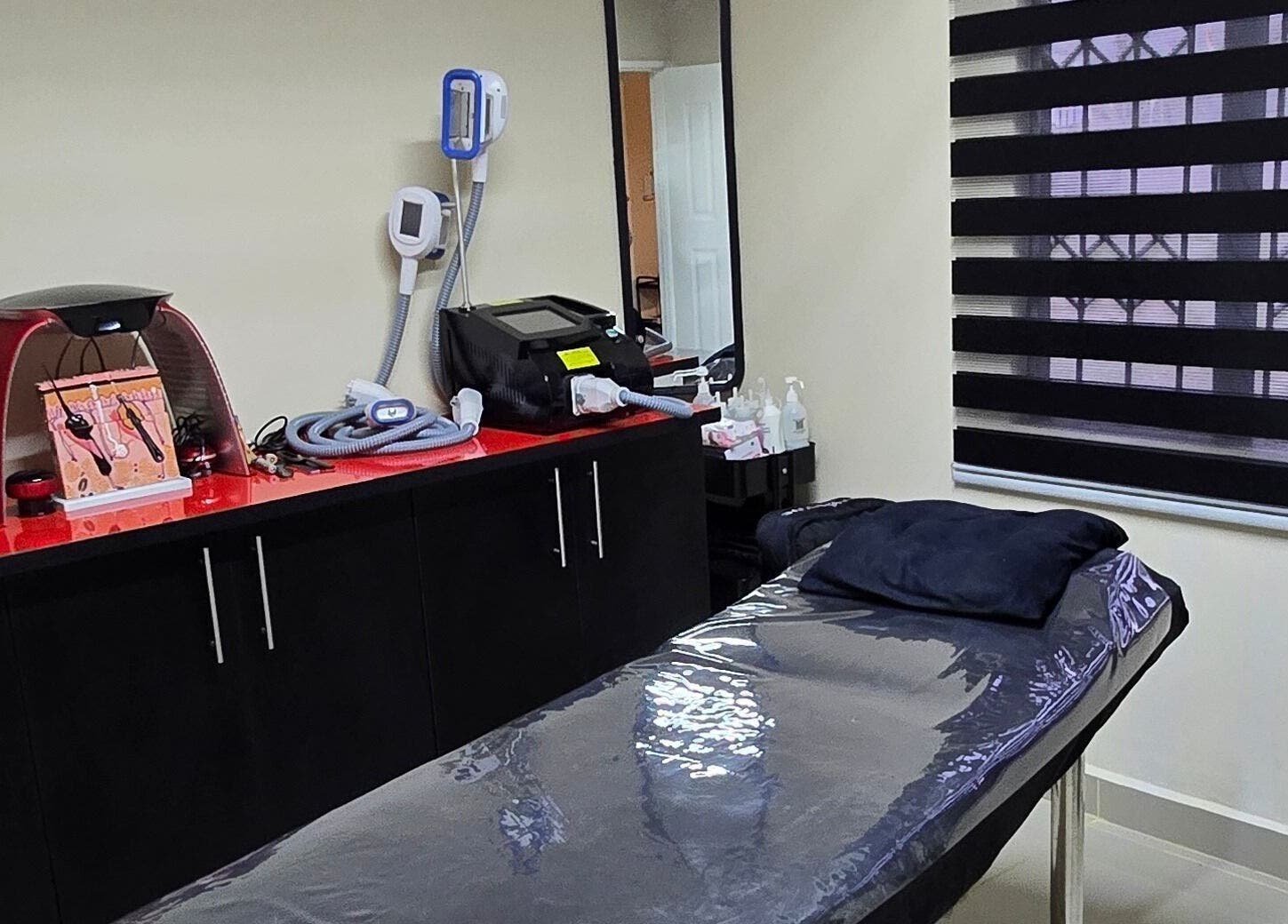 Sozo Laser Aesthetics treatment room in Phoenix, Kwazulu-natal, ZA with equipment and comfortable table.