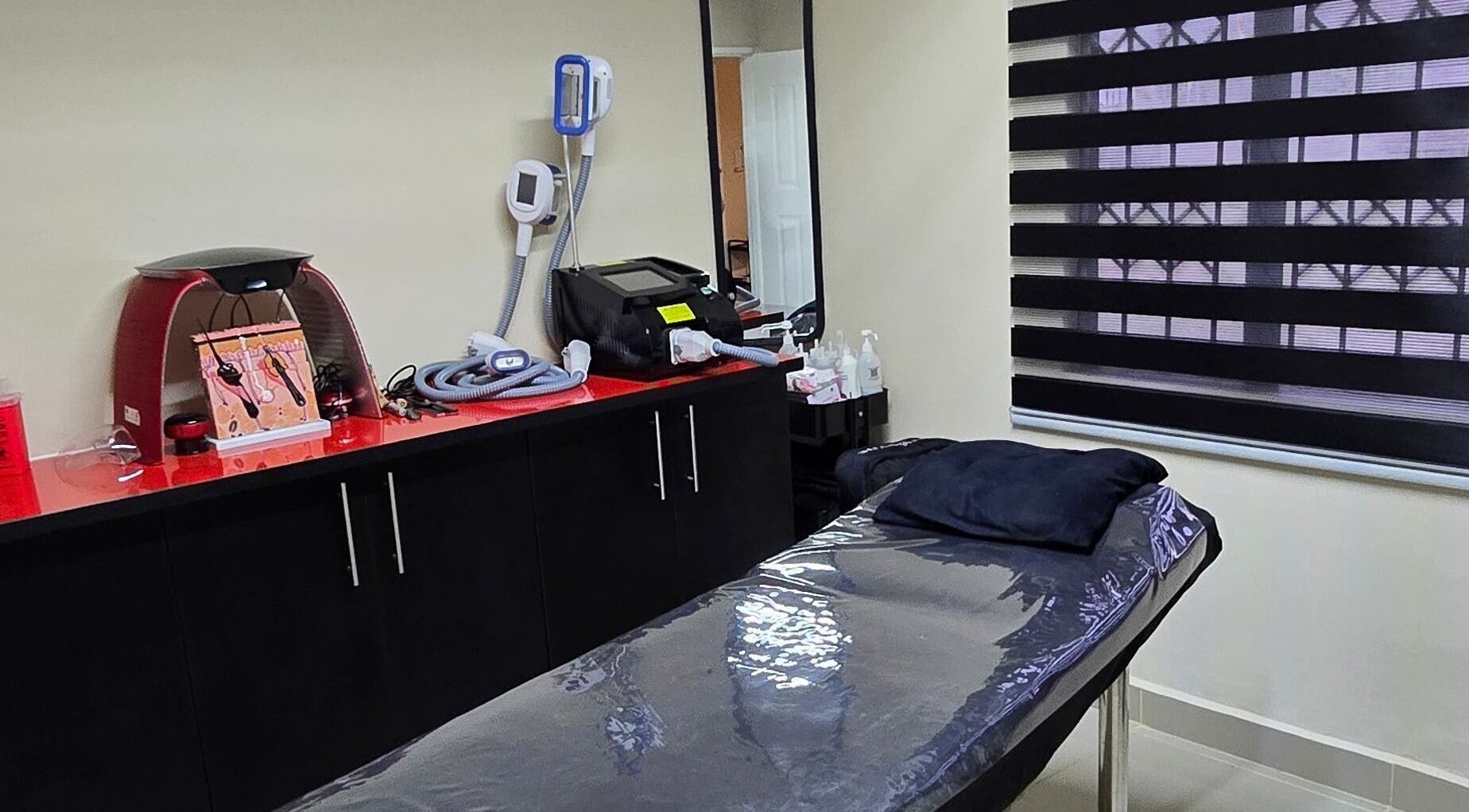 Sozo Laser Aesthetics treatment room in Phoenix, Kwazulu-natal, ZA with equipment and comfortable table.